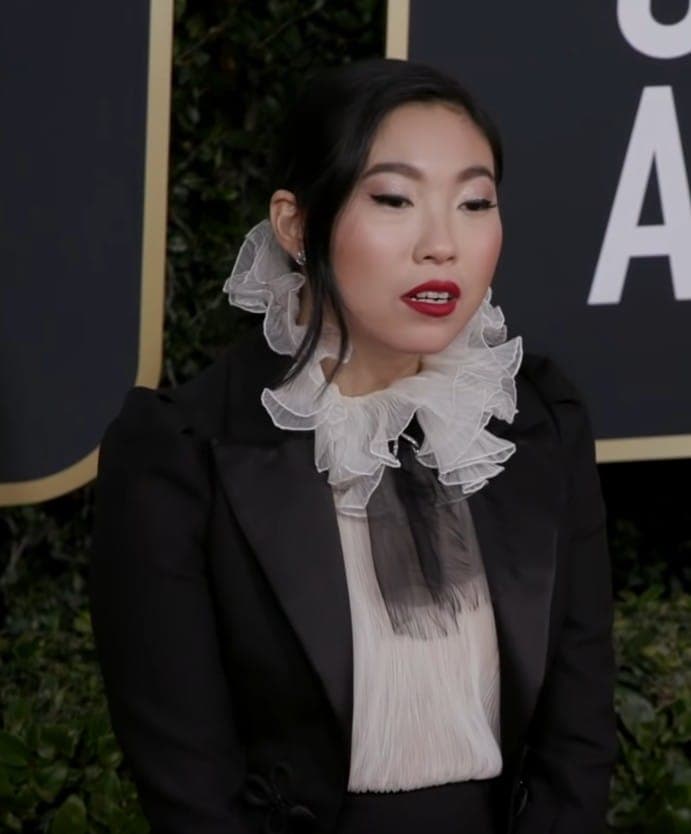 Farewell-era Globes carpet — soft-smile billboard vs hard jaw silhouette literacy.