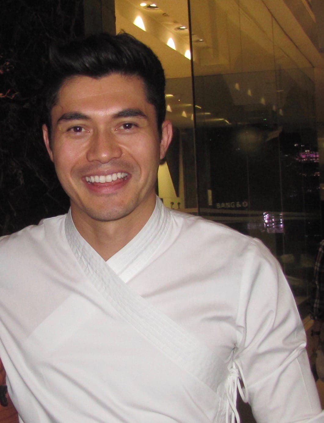 CRA filming wrap still — soft-smile Southeast Asian leading-man energy without premiere flash.
